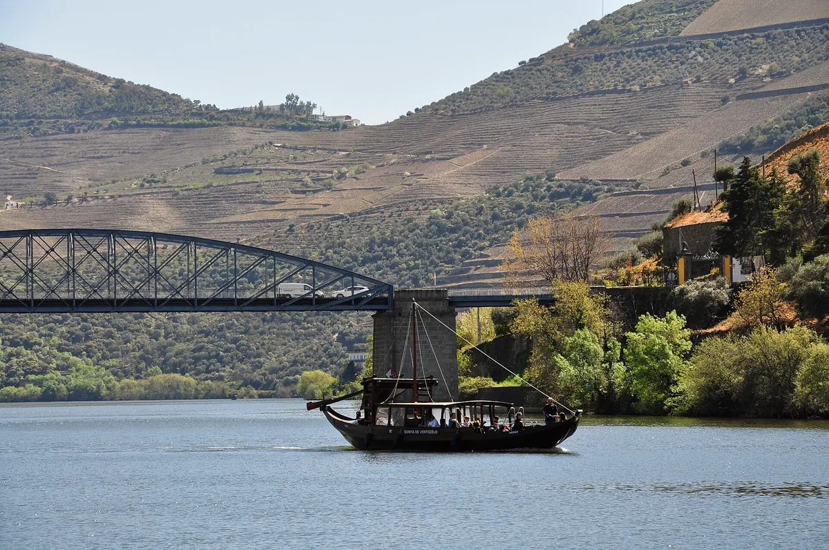 A rabelo boat on the Douro near Pinhão beneath terraced hills