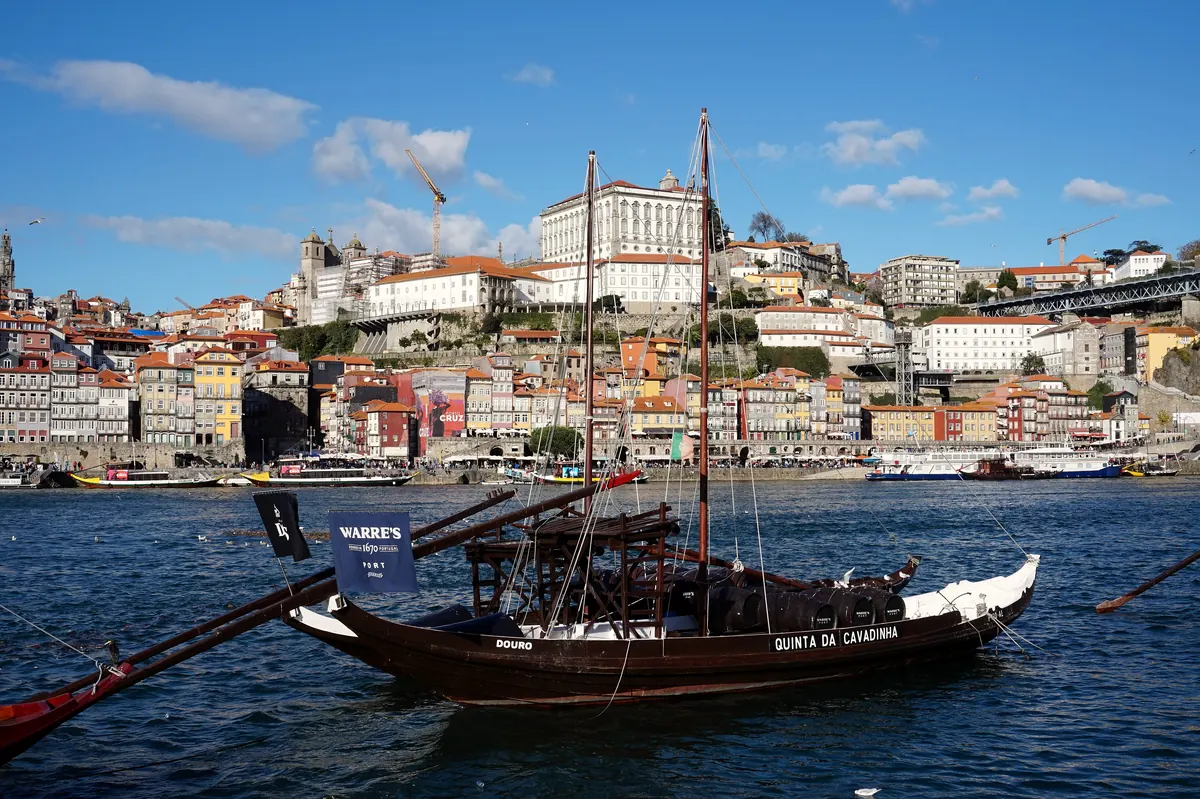 A rabelo boat on the river in front of the Sé and Ribeira