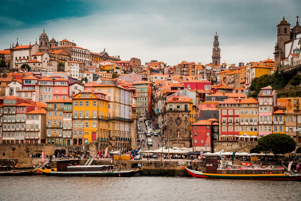 Tall, colourful townhouses stacked up the hillside of Porto's Ribeira district